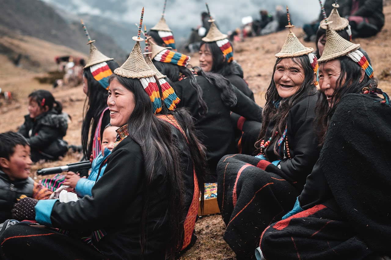 Layap woman sit on the sidelines at the Royal Highlander Festival in Laya, Bhutan.