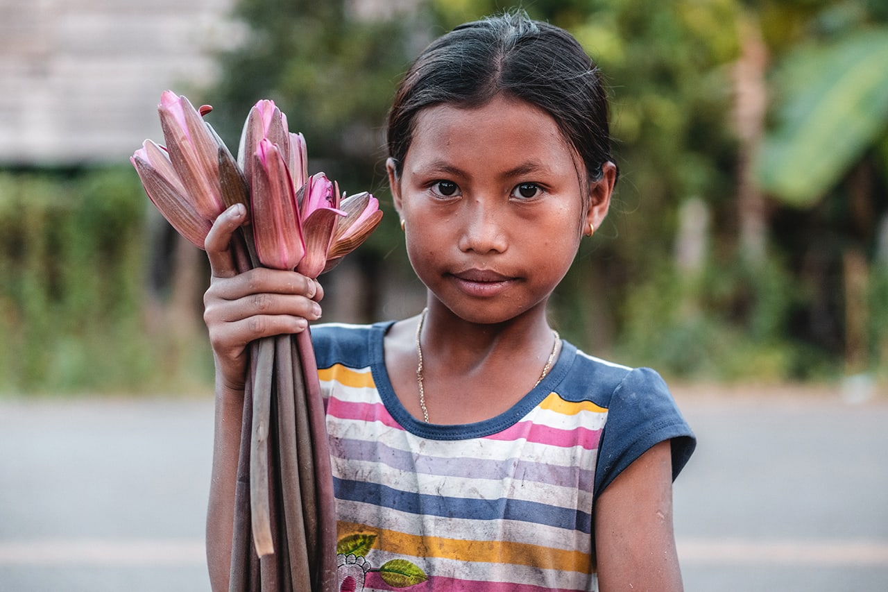 Portrait of a young girl holding lotus flowers in Siem Reap, Cambodia.