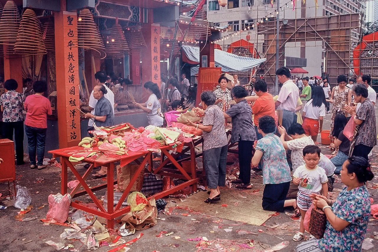 Woman making offerings at the Monkey God ceremony in Hong Kong.