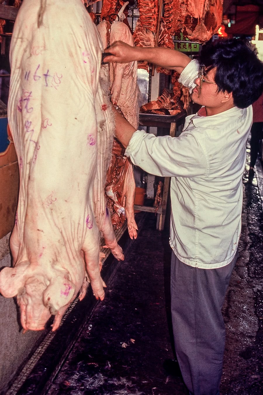 A butcher cuts meat in Mongkok, Hong Kong.