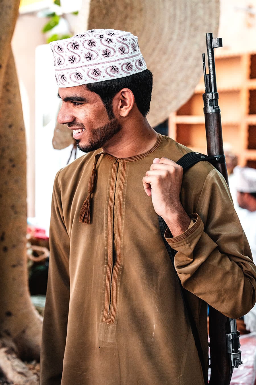 A man holding a riffle at the Niza Gun Market in Oman.