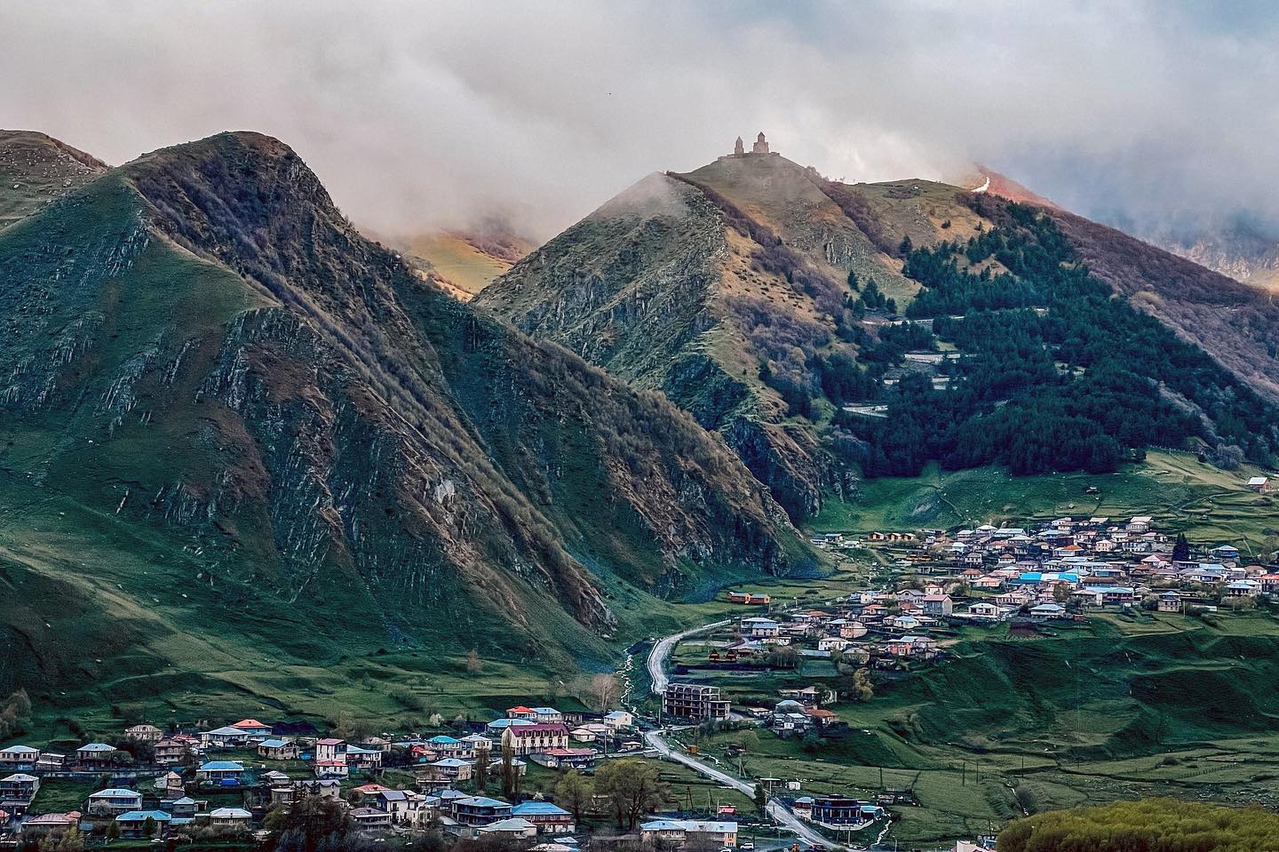 Stunning view from my hotel balcony of Kazbegi and Gergeti Church in the mountains of Georgia. It was a rainy afternoon but I managed to get some amazing breaks in the weather.